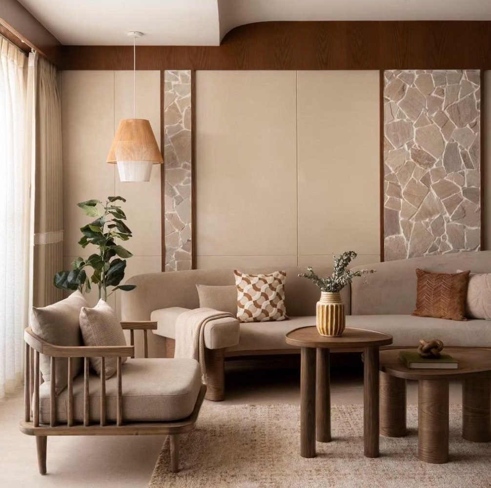 Living room with broken-stone wall panels, timber tables, and a spindle armchair