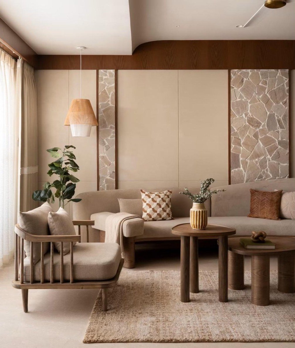 Living room with broken-stone wall panels, timber tables, and a spindle armchair
