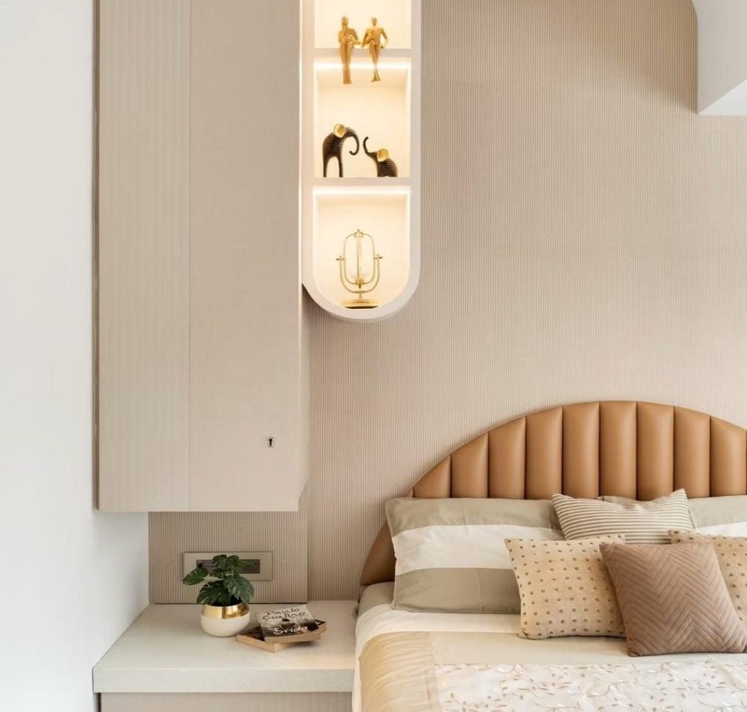 Bedroom with channelled leather headboard and lit display niche