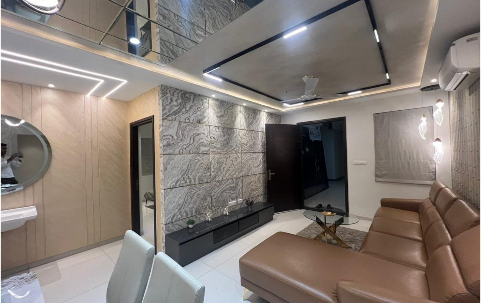 Double-height living with marble wall and leather seating