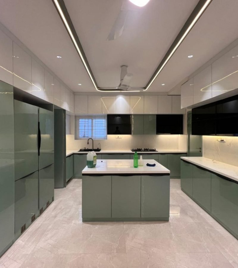 Gloss sage kitchen with island, tall units, and linear ceiling light