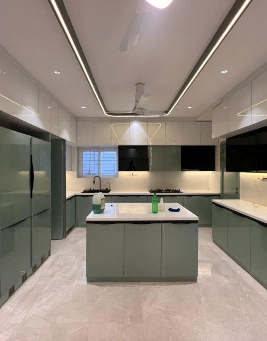 Gloss sage kitchen with island, tall units, and linear ceiling light