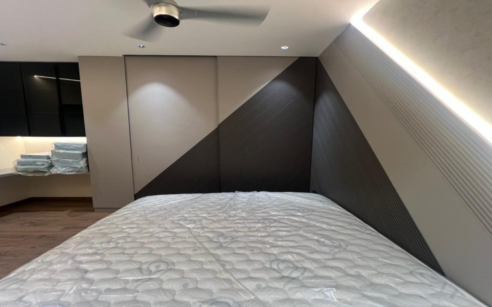 Bedroom with a diagonal fluted headboard wall and a floating platform bed