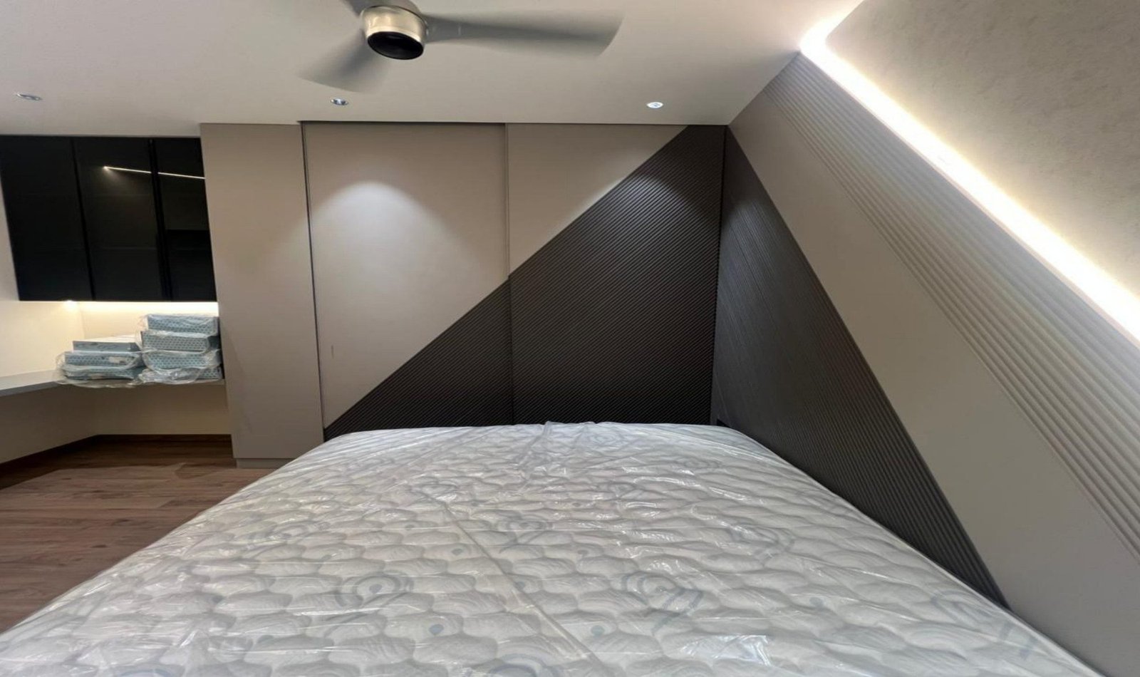 Bedroom with a diagonal fluted headboard wall and a floating platform bed