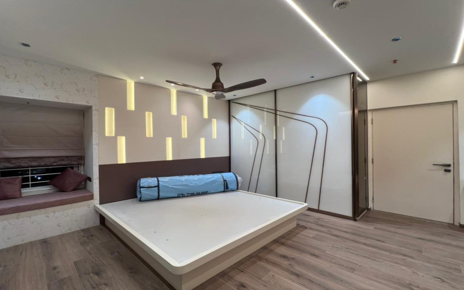 Bedroom with window seat and vertical light slots