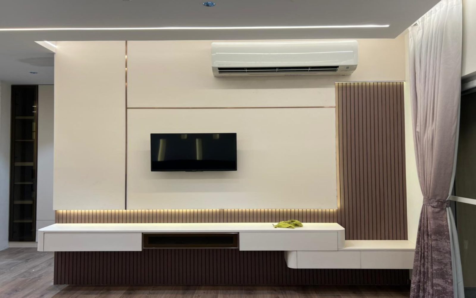 Media wall with fluted timber, floating console, and copper inlay