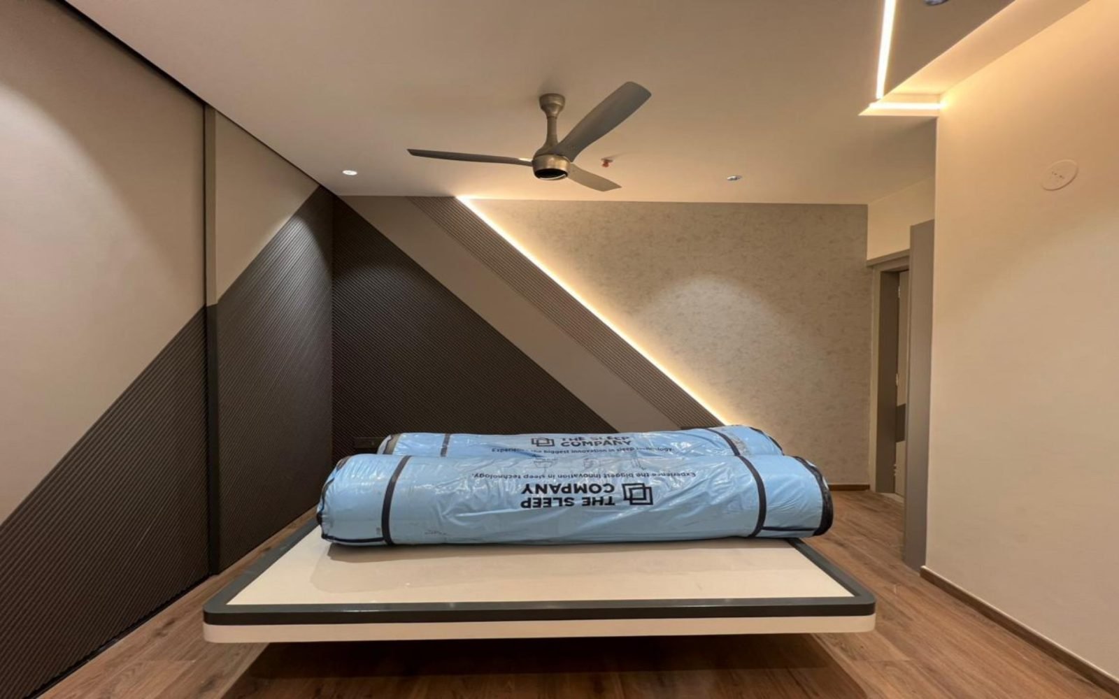 Bedroom with diagonal timber and rolled mattress on a floating bed